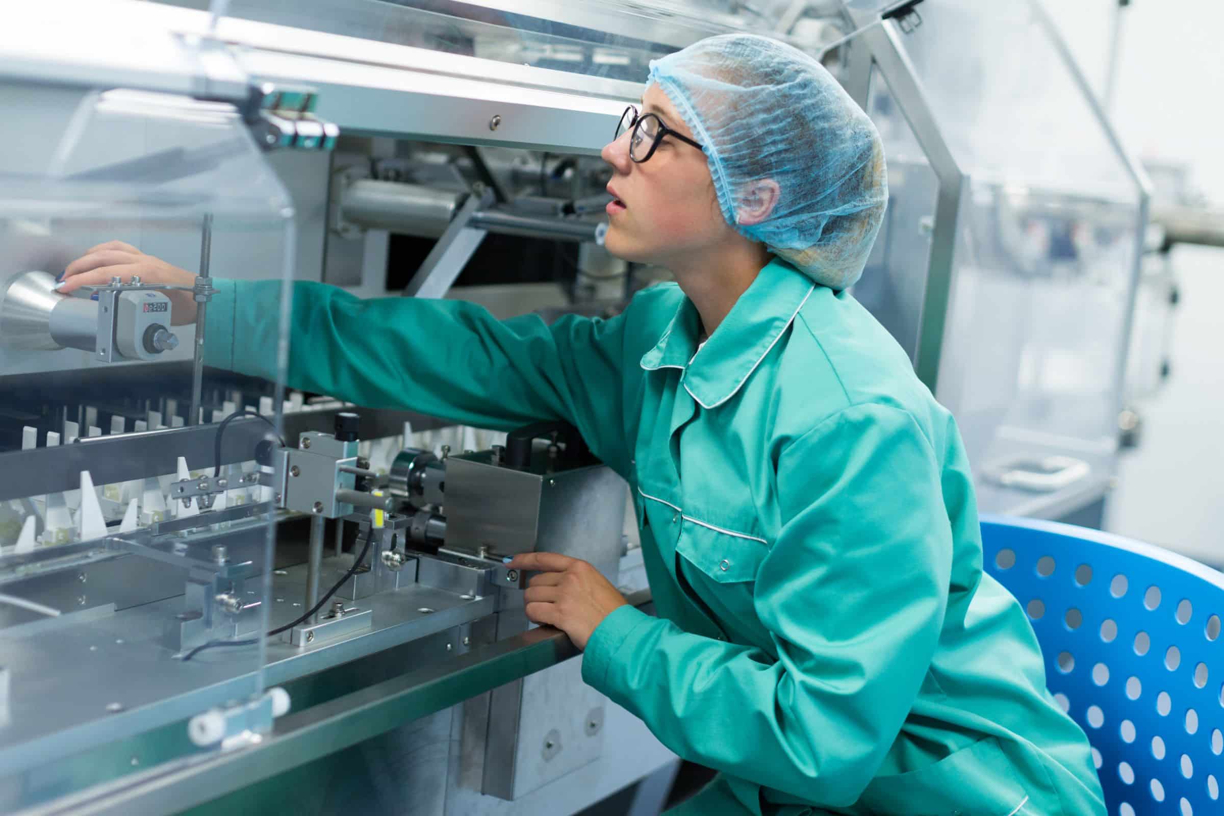 factory worker checking machine