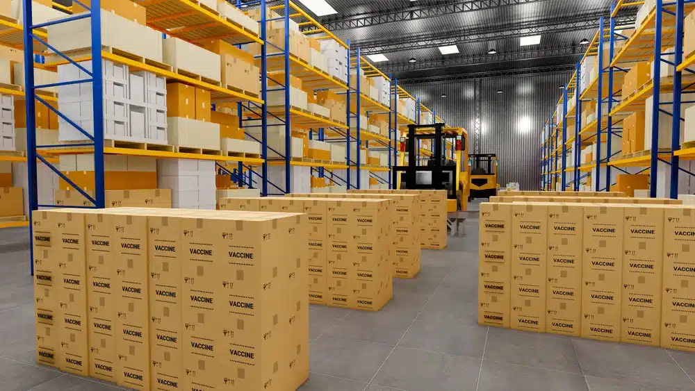 Warehouse filled with stacked vaccine boxes and forklift for pharmaceutical distribution