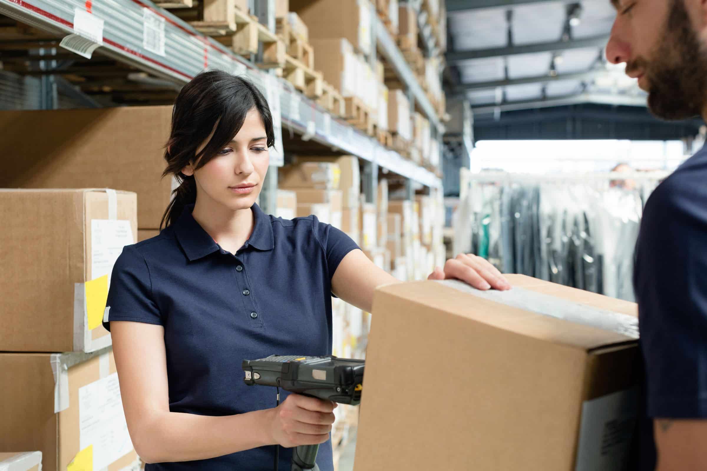 warehouse worker scanning a barcode on a box with an RF scanner