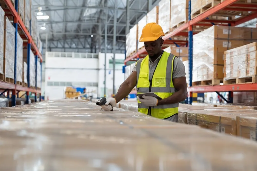 worker scanning pallet during warehouse receiving process