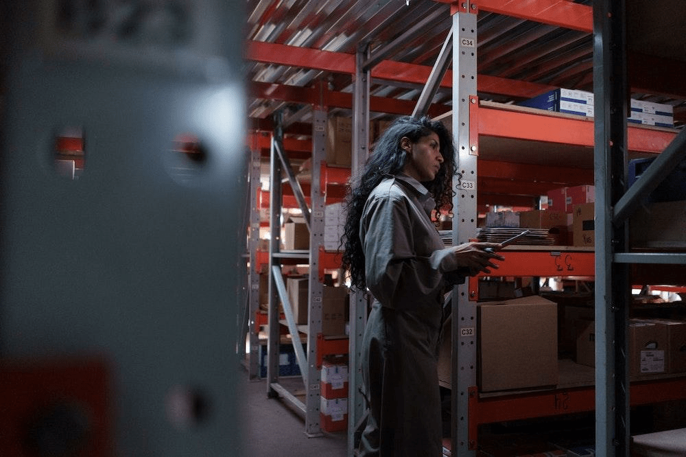 woman in warehouse holding a tablet