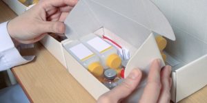box of pill bottles and vials