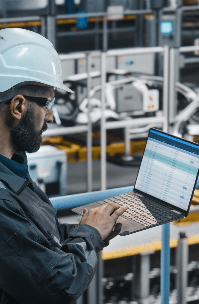 man in manufacturing facility on laptop