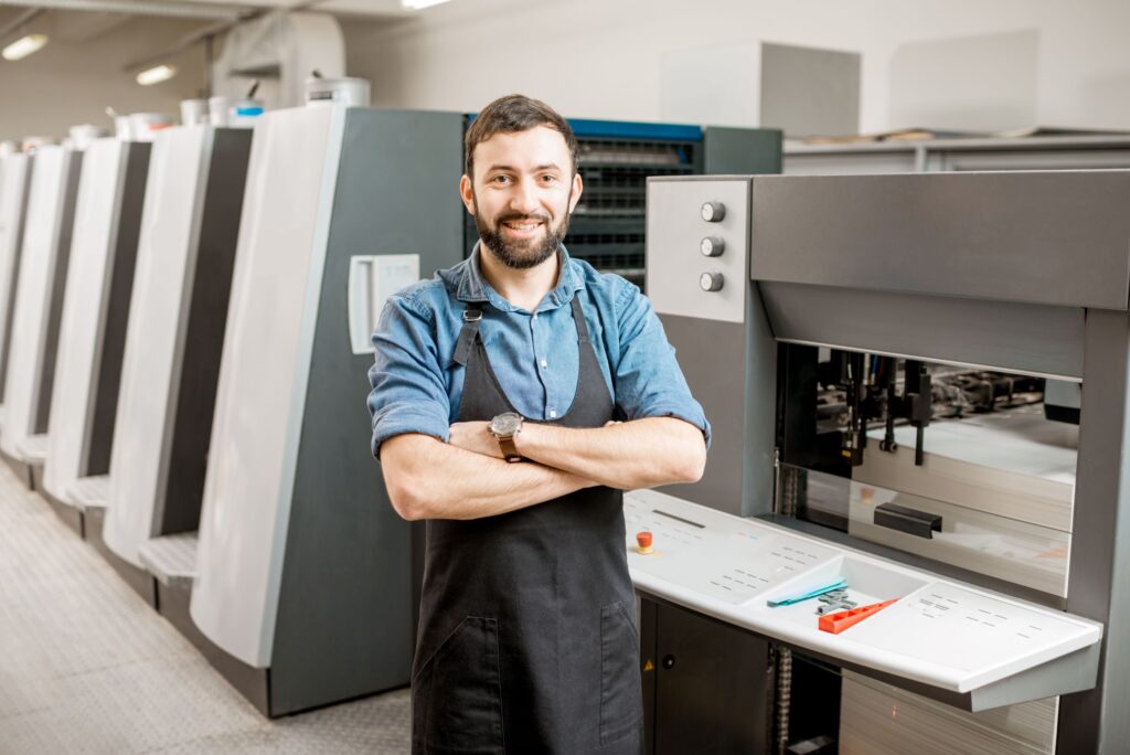 man standing in front of manufacturing machines