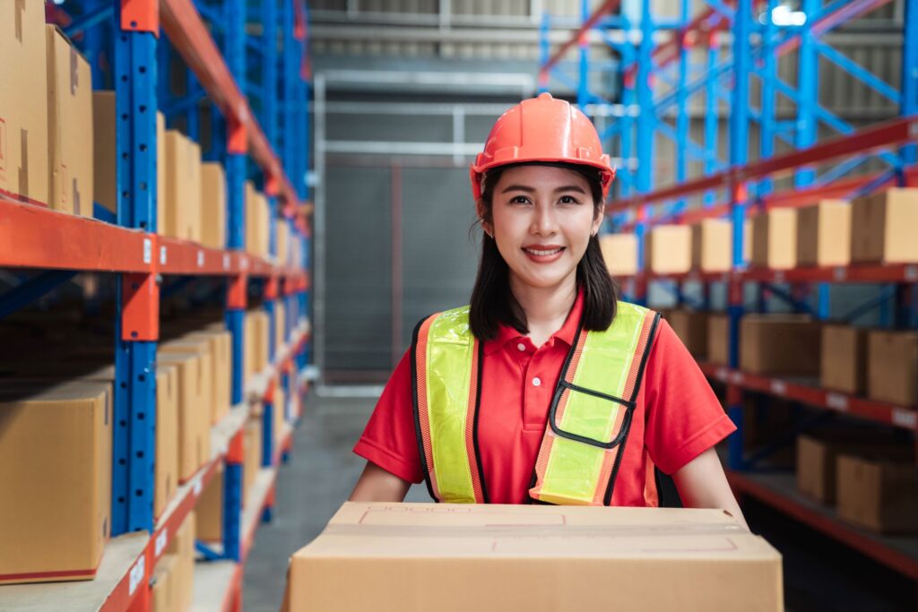 portrait-of-warehouse-worker-smiling-and-happy-in warehouse aisle