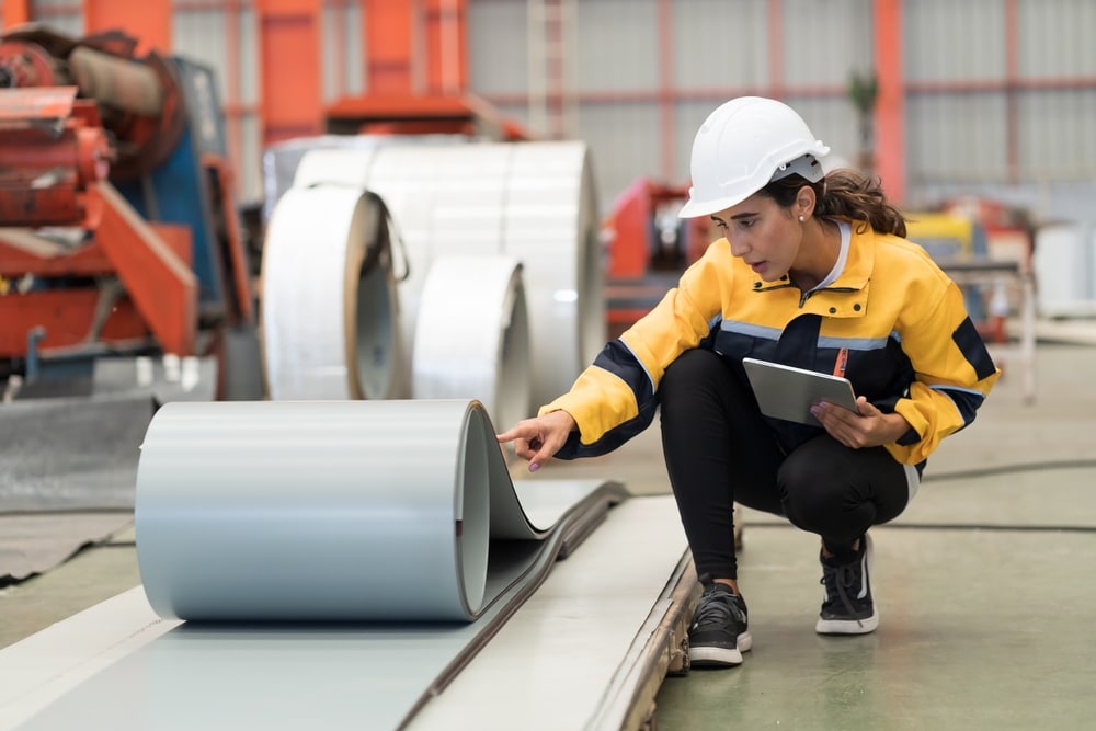 female manufacturing worker using shop floor management software