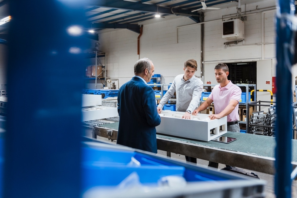 shop floor manager talking with two workers