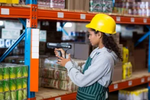 warehouse worker scanning a barcode on a the warehouse rack