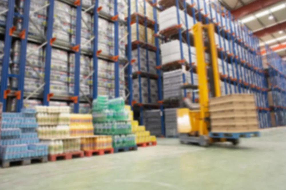 blurred picture of a forklift moving a pallet in a warehouse